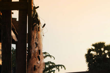 Close up old fish traps, fishing net on golden sky backgroundの写真素材