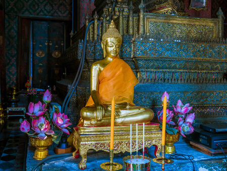 Gold pained Buddha statues with 2 candles and 2 joss stick.のeditorial素材