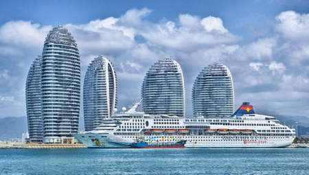 Cruise ship in bay with skyscrapers in backgroundのeditorial素材