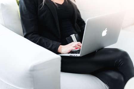 Woman Entrepreneur Working on Silver Laptopのeditorial素材