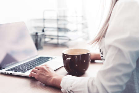 Woman Working and Drinking Tea in The Office