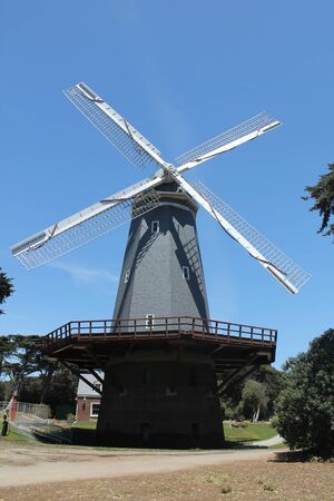 Traditional windmill with trees and bushes around