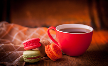 Macaroons with coffee on wooden table.の写真素材
