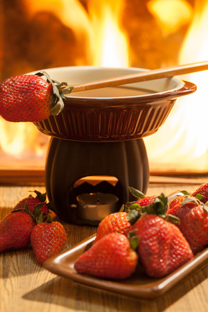 Chocolate fondue with oven on wooden tableの写真素材