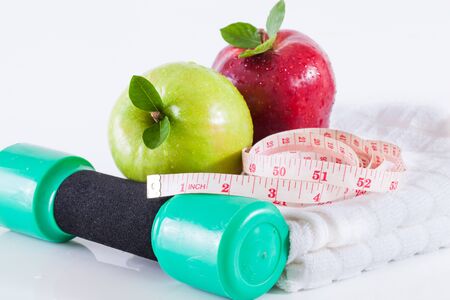 Dumbells with measuring tape and applesの写真素材