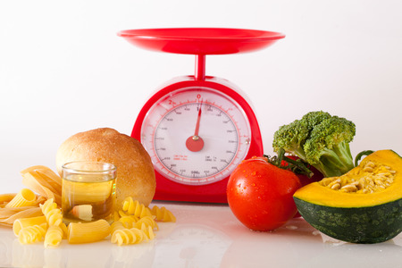 Foods high in carbohydrate on a scalesの写真素材
