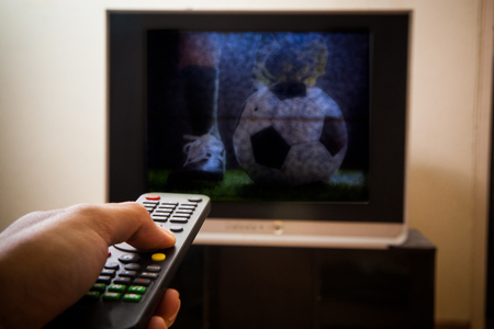 Watching soccer game on tv at home