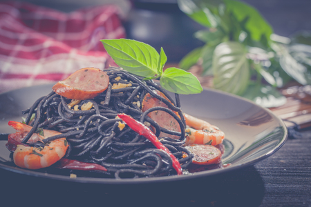 Black spaghetti with shrimps and sausageの写真素材