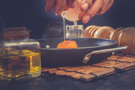 Man making breakfast with fresh eggsの写真素材