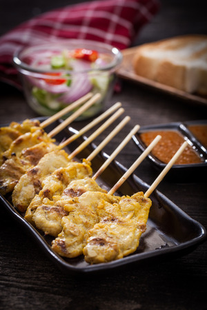 Chicken  satay grilled meat, served with peanut sauceの写真素材