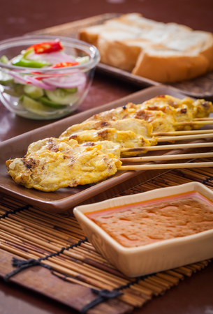 Chicken  satay grilled meat, served with peanut sauceの写真素材