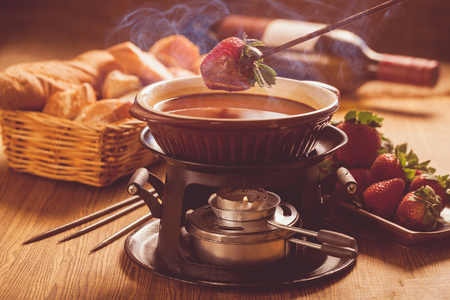 Chocolate fondue with oven on wooden tableの写真素材