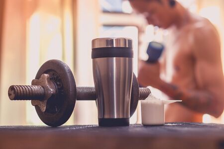 Whey protein shaker and dumbbellsの写真素材