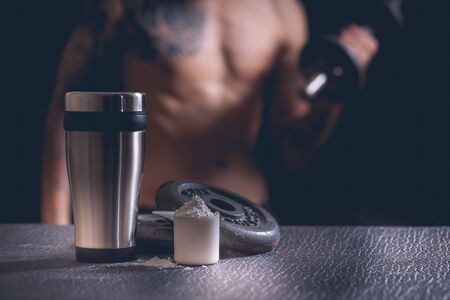 Whey protein shaker and dumbbellsの写真素材