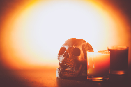 Scary Halloween skull bones with candleの写真素材