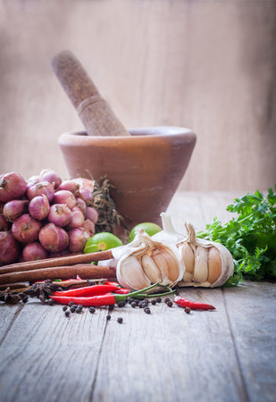 Spices and vegetables with mortarの写真素材
