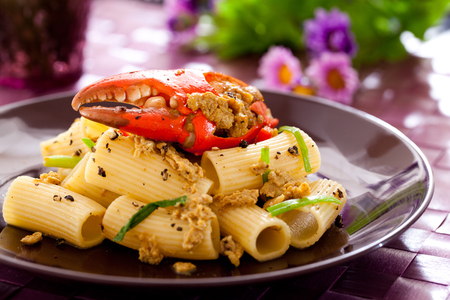 Fried crab in yellow curry with rigatoni.の写真素材