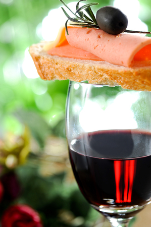 Tapas on crusty bread with red wineの写真素材