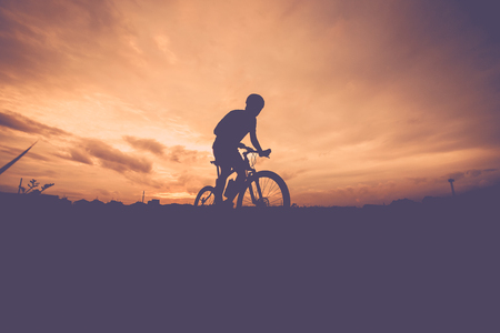 Silhouette of mountain bike ridesの写真素材