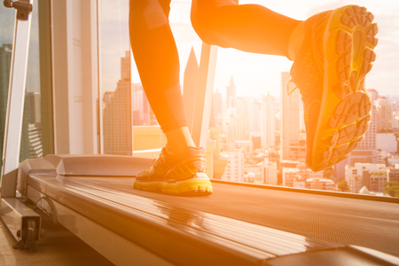 Man running in a gym on a treadmill