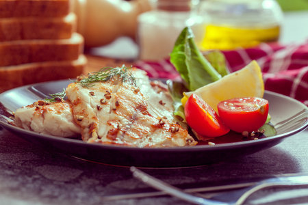 Grilled fish steak with vegetablesの写真素材