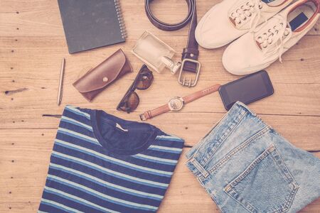Man's collection of clothes in casual style on a wooden backgroundの写真素材