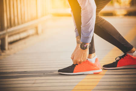 Runer with smartwatch at sunsetの写真素材