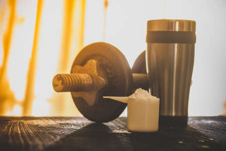 Whey protein shaker and dumbbellsの写真素材