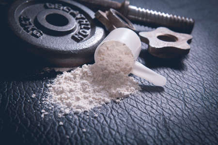 Whey protein shaker and dumbbells
