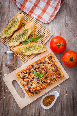 Homemade bacon pizza with garlic breadの写真素材