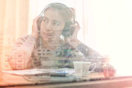 Woman listening music with headphones and reflection building
