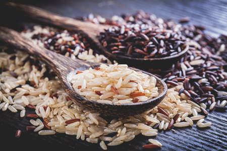 Brown rice on wood backgroundの写真素材