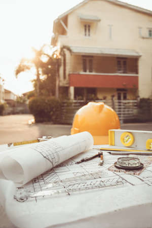 Tools on architect blueprints with house