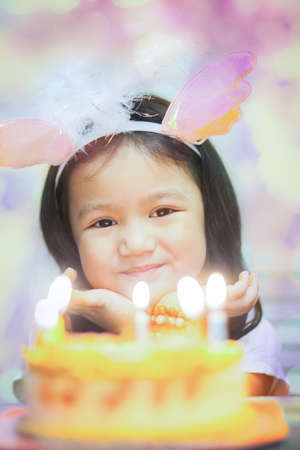 Little pretty girl with birthday cakeの写真素材