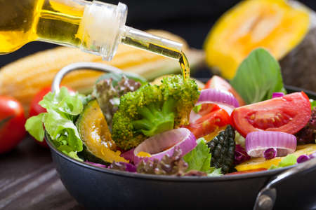 Olive oil and  fresh vegetable saladの写真素材