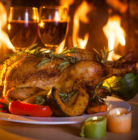 Roasted thanksgiving turkey on restaurant table with wineの写真素材