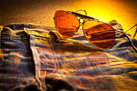 Faded blue jeans with vintage sunglasses