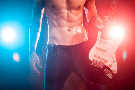 Musician playing the guitar on the stageの写真素材