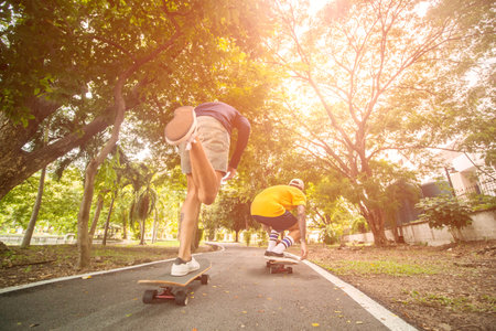 skateboarders  skating active performance on a skateboard at parkの写真素材