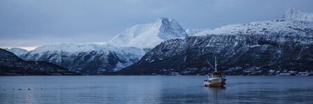Boat in a winter fjord in Norwayの写真素材