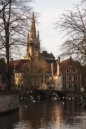 Beautiful church with reflection on the channel Brugge,Belgiumの写真素材