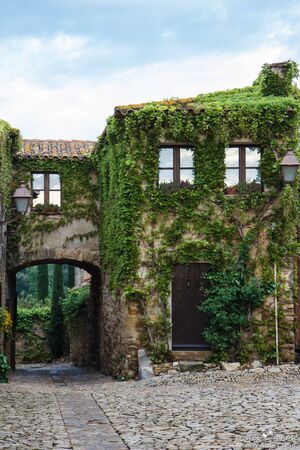 House covered with ivy leaves, Peratallada, Spainの写真素材