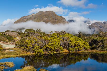 Mountain lake and clouds , Key Summit Trail, Routeburn Track, New Zealandの写真素材