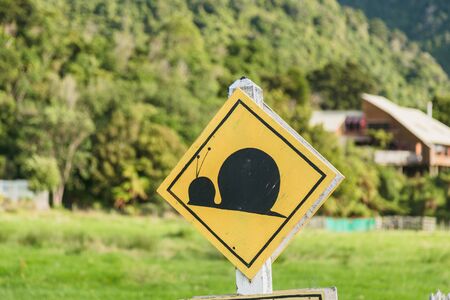 Attention snail. Danger yellow road sign. Slow driver Cautionの写真素材