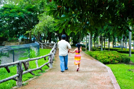 Thai girl holding her father by handの写真素材