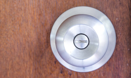 silver knob on wooden door