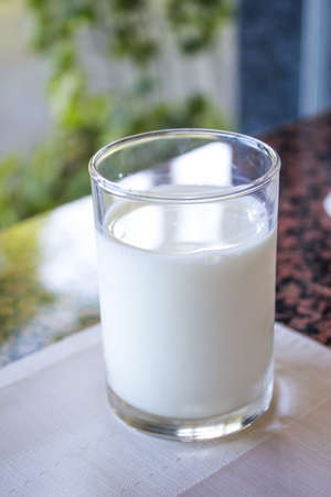 glass of milk on the tableの写真素材