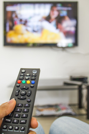 channel surfing with remote control in handの写真素材