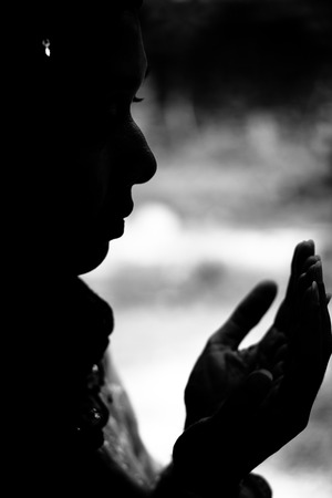 silhulate of muslim woman prayingの写真素材