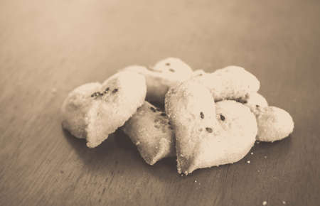 heart shaped cookies on wood background in vintage filterの写真素材